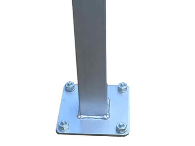 A steel base plate post, four bolts and nuts fixed on the plate.